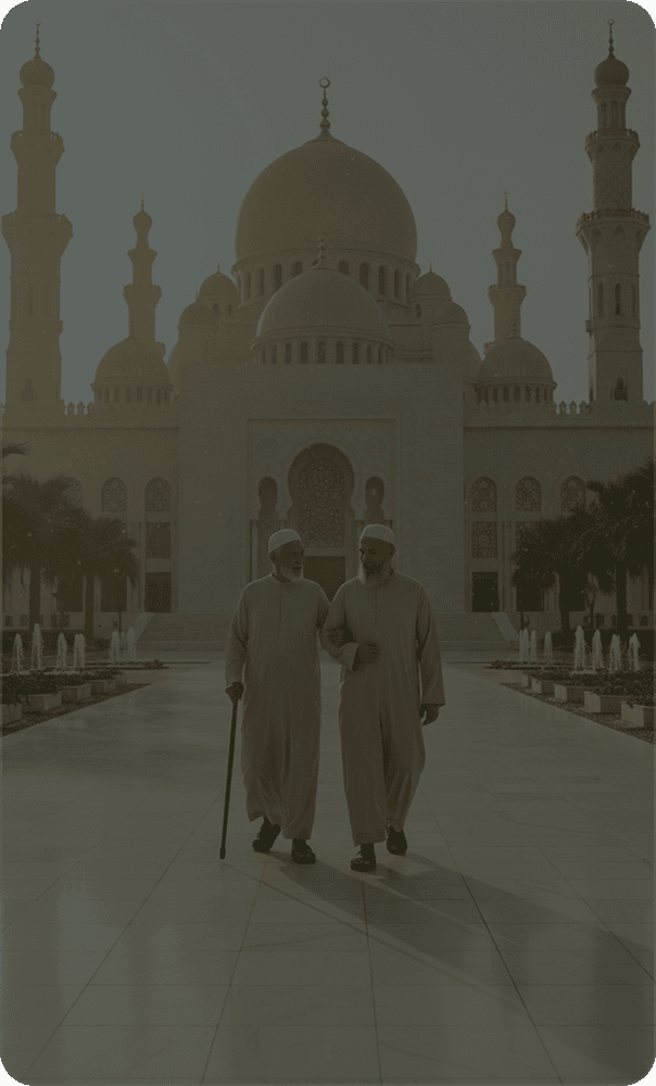 Two elders walking arm in arm along a mosque courtyard between fountains
