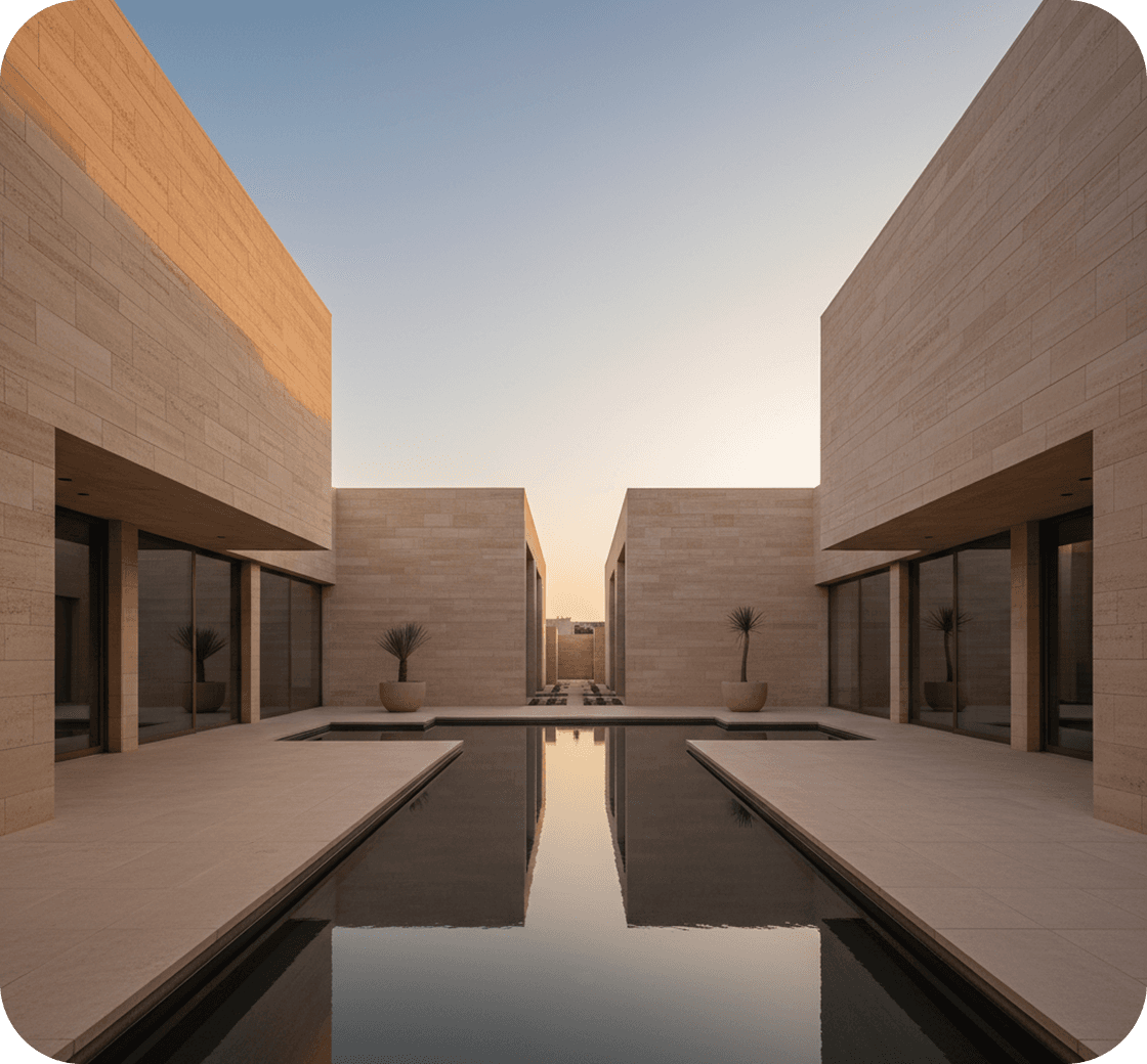 A stone residential courtyard with a long reflecting pool at dusk