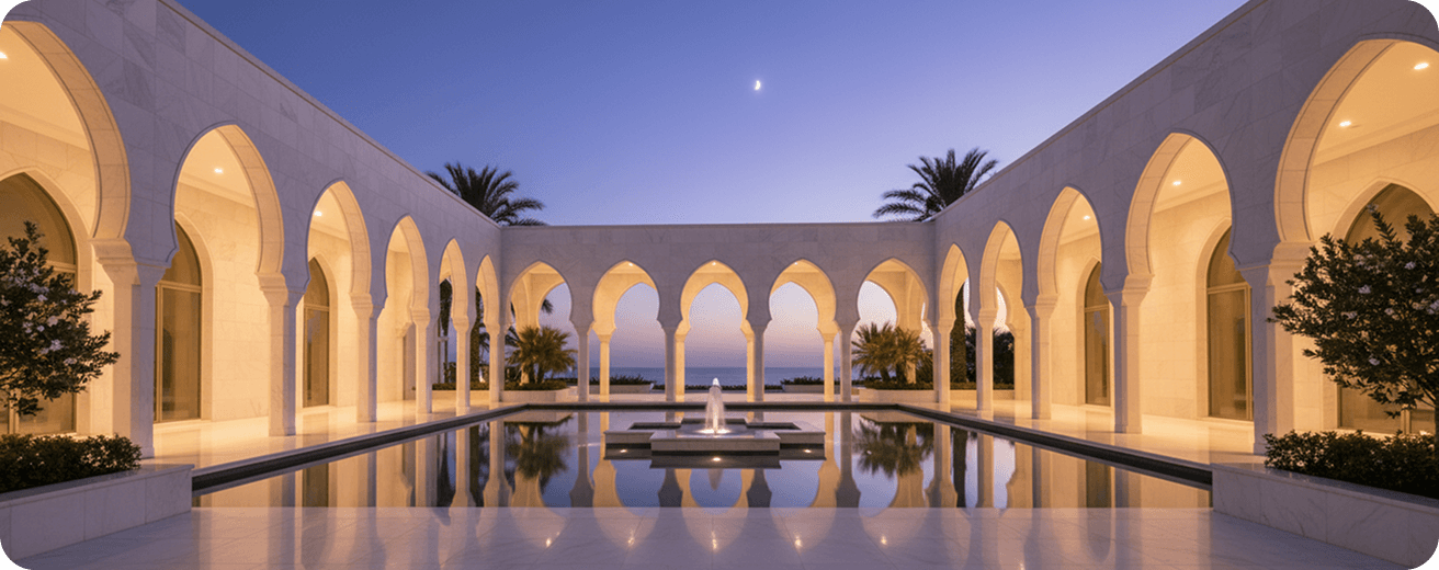 An arcaded courtyard and reflecting pool lit at dusk
