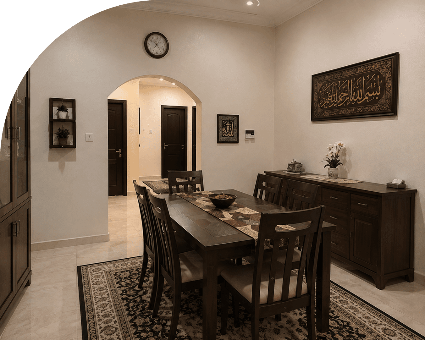The dining room of a Madinah Residence apartment, framed by an interior arch