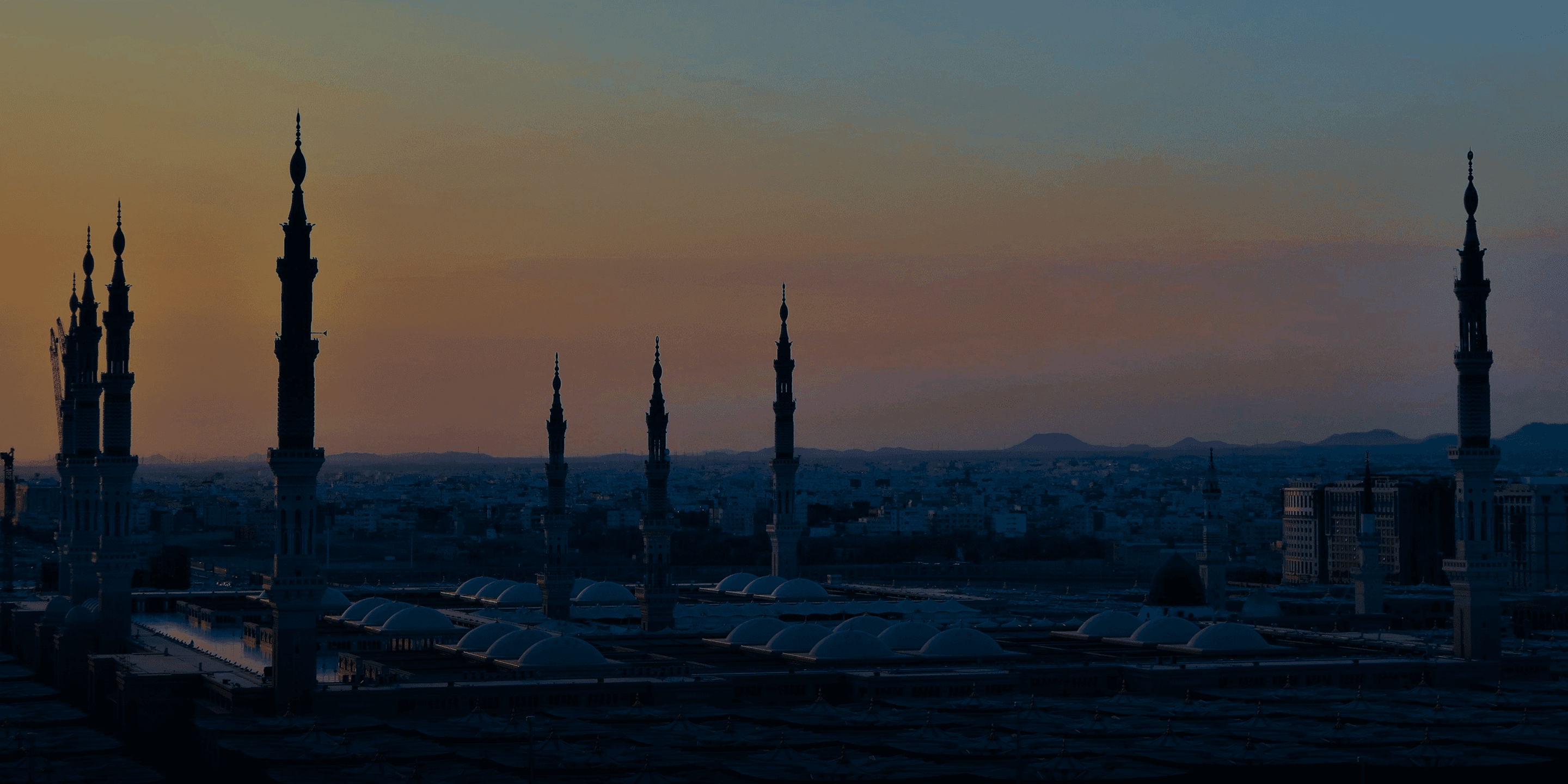 Al-Madinah before dawn, the minarets of Masjid al-Nabawi above the sleeping city